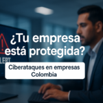 Ciberataques en empresas Colombia: profesional revisando alerta de seguridad digital en computador en oficina corporativa